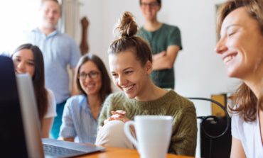 Group Of People Watching a Gray Laptop