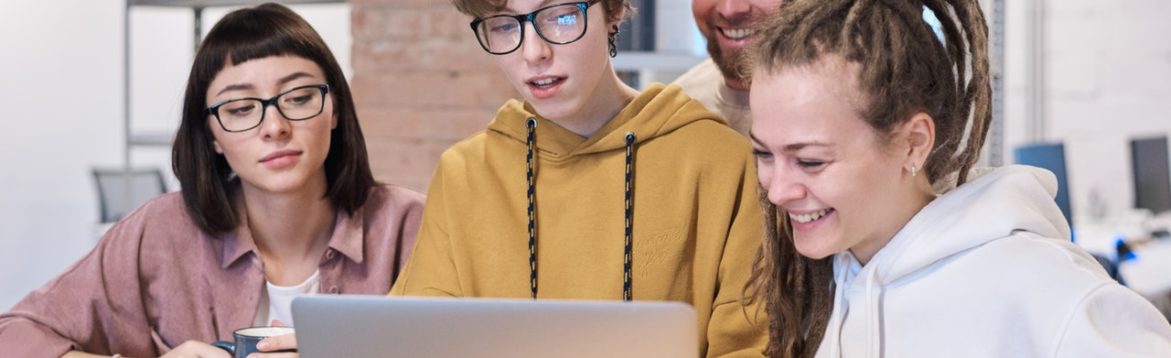 Photo of people looking on the laptop