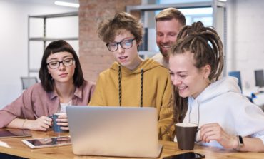 Photo of people looking on the laptop